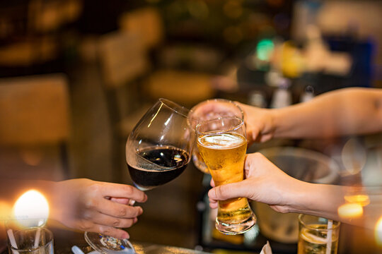 food and drink male friends are happy drinking beer and clinking glasses at a bar or pub.