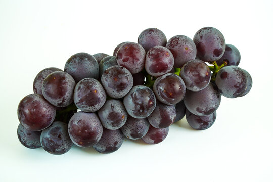 Freshly Washed Dark Purple Grapes with Bloom on White Background
