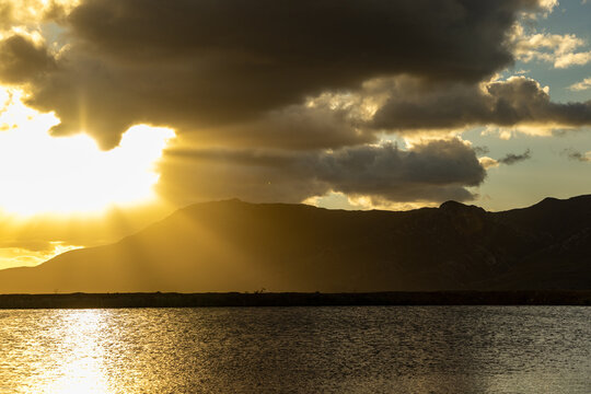 god rays, sunset light over mountains and pond, Stanford, South Africa