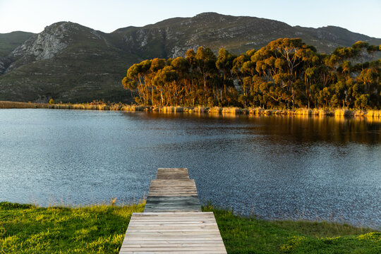 wooden boat launch over pond at sunset, Stanford, South Africa
