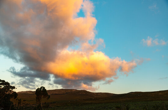 beautiful sunset clouds hovering over land