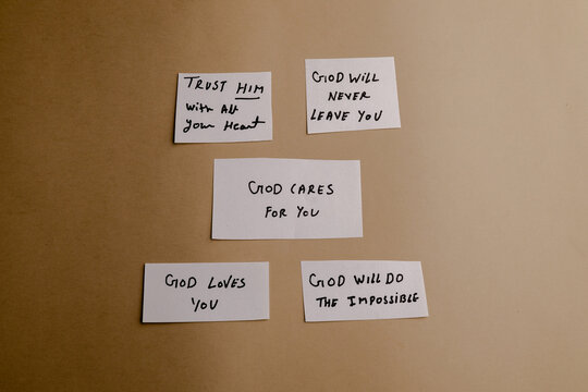 Inspirational handwritten notes with religious faith messages on paper cards placed on a neutral background for spiritual encouragement use