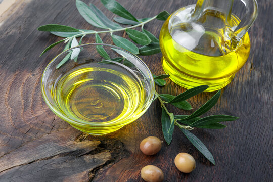 organic olive oil in a glass bowl on rustic wood
