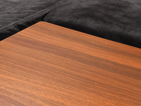 Luxurious dark leather sofa paired with a premium-grade walnut wood table.