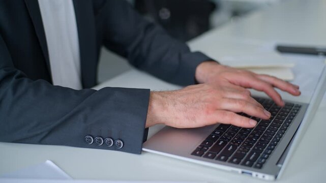 Cropped view male hands chatting with laptop unrecognizable Caucasian business man using computer internet chat online corporate technology working at table in office unknown businessman employer work
