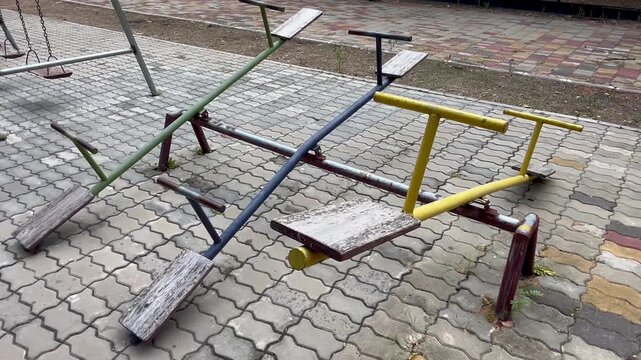 Vintage metal seesaws at outdoor playground