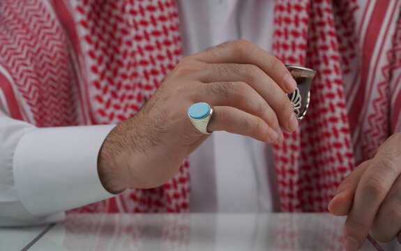 Traditional Middle Eastern man in keffiyeh displaying a ring