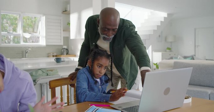 African American family father guiding youth girl writing at table, seeing online call on laptop