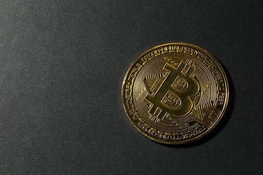Electronic decentralized money concept. Bitcoin coins on black background. Top view.