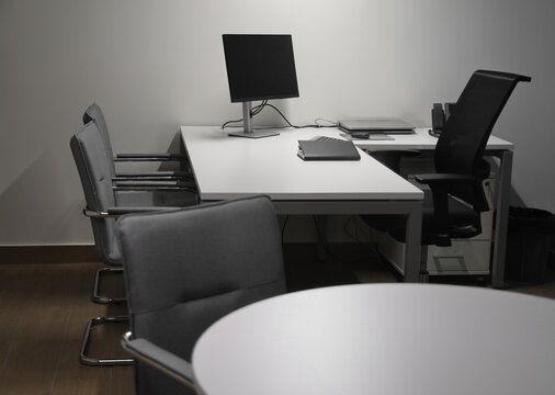 Spacious office interior with personal computers laptop telephone on 2 two tables modern new small office interior.