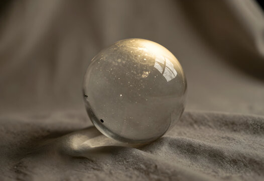 Future prediction and foresight crystal ball on textured fabric clarity vision intuition and spiritual guidance in a minimalist setting
