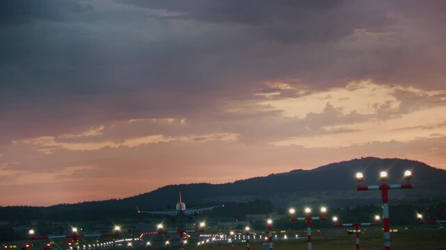 Jet airliner landing on runway with tire smoke rising at touchdown. Passenger airplane lands on an airport runway