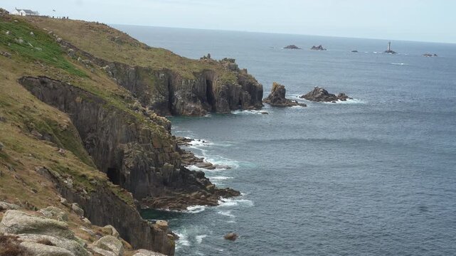 Breathtaking landscape of rugged steep cliffs and the vast Atlantic Ocean at Land's End, Cornwall.
