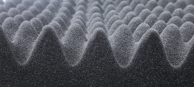 Materials that absorb sound waves instead of blocking them.