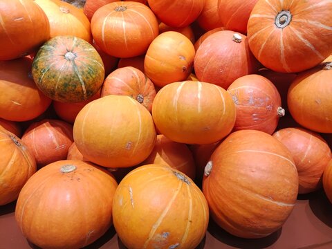 A pile of pumpkins. Fresh pumpkins stacked together. Close-up.