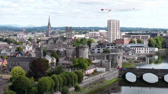 Aerial Cityscape of Limerick with King John's Castle and Cathedral, Ireland. Drone pull back