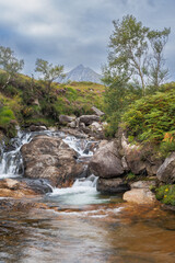 Mountain stream cascades over rocks in lush greenery in the Glen Rosa valley on Arran, Scotland © nicholasjermy