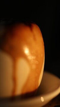 Close-Up Espresso with Creamy Foam and Chocolate Drizzle on Dark Background