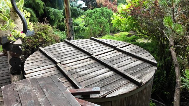 Closed Wooden Outdoor Hot Tub in Lush Green Backyard Garden
