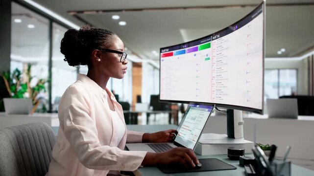 Auditor Carefully Tracking User Activity Logs On Laptop