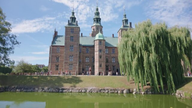 Copenhage, Denmark. August 13, 2026, Revealing the facade of Rosenborg Castle in Copenhagen, Denmark. Historic renaissance building with a moat on a sunny day with blue sky