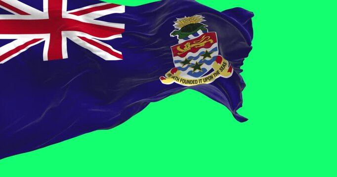 Flag of Cayman Islands waving in the wind isolated on green background