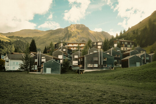 Swiss alpine village of dark wooden chalets beneath a mountain peak