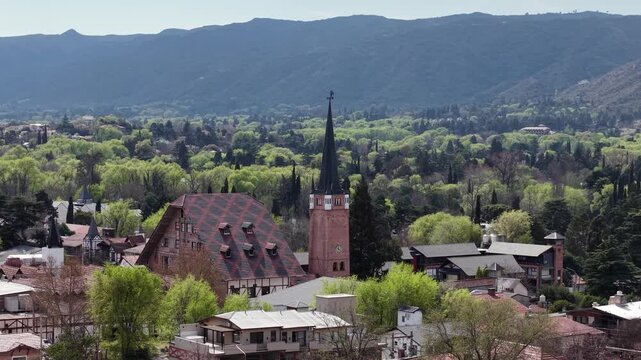 Aerial view of Villa General Belgrano clock tower and mountains in Cordoba Argentina