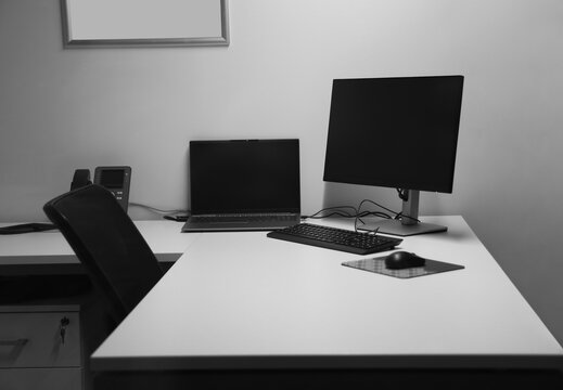 Spacious office interior with personal computers laptop telephone on 2 two tables modern new small bank office interior.