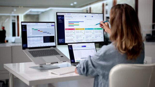 Bank Manager Reviews Customer Accounts On Computer