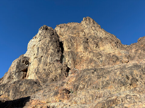 A rocky peak of Mount Uhud rises against a clear blue sky, Al Madinah Province, Madinah, Saudi Arabia