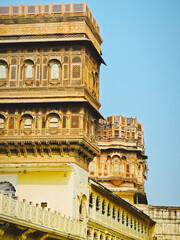 Ornate Carved Sandstone Facade with Jharokha Balconies and Towers at Mehrangarh Fort in Jodhpur Rajasthan © Samarth Jain