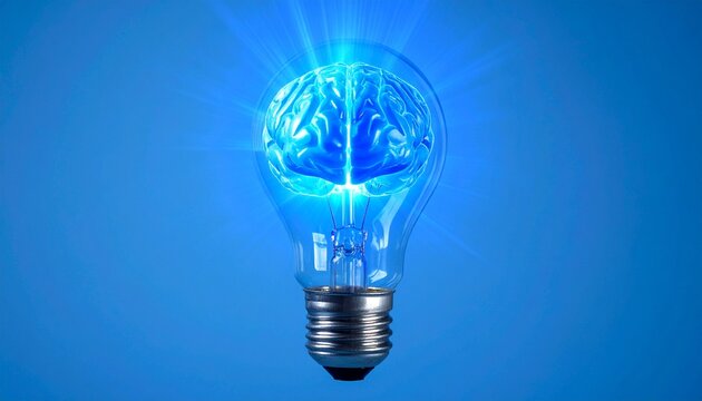 Luminous brain inside a clear incandescent bulb during innovation concept with glowing blue light on blue background concept