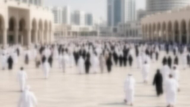 Blurred crowd leaving a sunlit stone plaza after prayers in a Gulf city