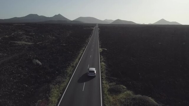 Car on a road through volcanic terrain