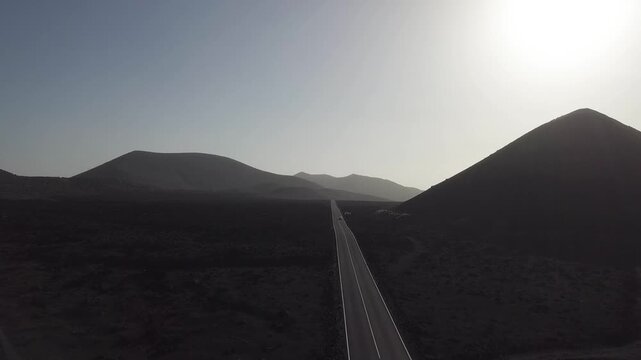 Road leading past a volcanic cone
