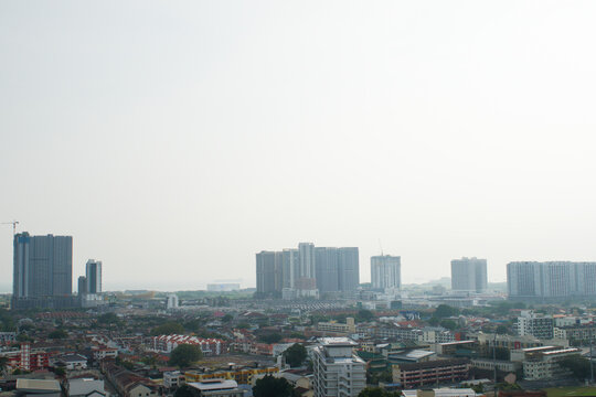 Hazy city skyline in Malaysia, representing transboundary haze, air pollution, poor air quality, environmental issues, reduced visibility, and regional pollution.
