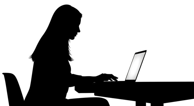 Silhouette of a woman working on a laptop computer