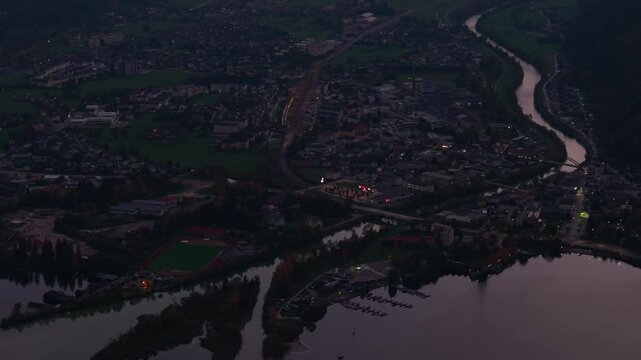 Aerial view of Ebensee town with Traun river lights during autumn twilight