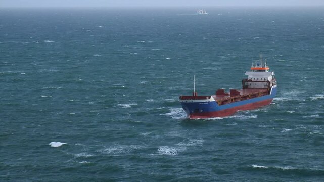 China Clay ship at sea approaching Fowey Harbour. Fowey is an important export port for China Clay (kaolin) mined in Cornwall, UK. This unladen ship is approaching Fowey harbour