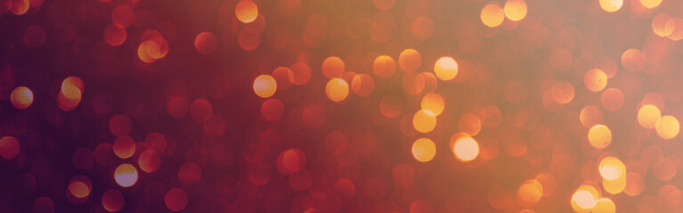 Warm festive bokeh background featuring soft red and orange blurred lights, creating a sparkling glow and shimmering effect for holiday celebrations and event designs © Vero Dibe