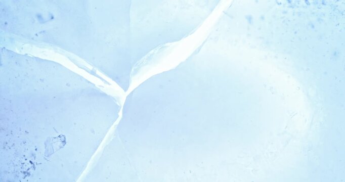 Super slow motion of falling crashed ice into white background. Filmed on high speed cinema camera, 1000 fps.