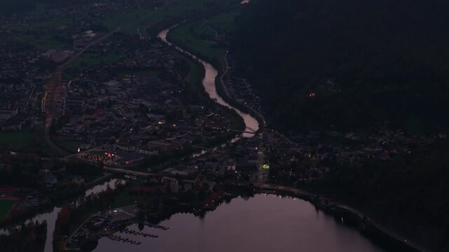 Aerial view revealing Ebensee town and Traun river valley during autumn dusk