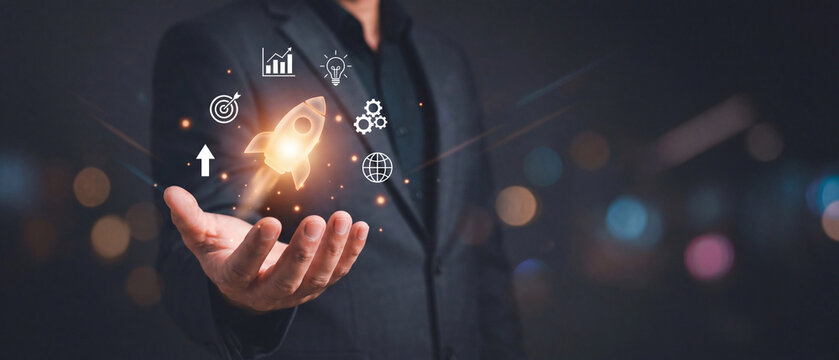 Above the man's hand is a rocket icon, symbolizing growth, achievements, progress, and productivity.