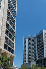 Fototapeta premium Tall office buildings under clear blue sky