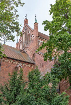Das Bild zeigt die mittelalterliche St.-Georgen-Kirche in Waren (M&uuml;ritz) mit ihrem charakteristischen roten Backsteinmauerwerk und den Giebeln.