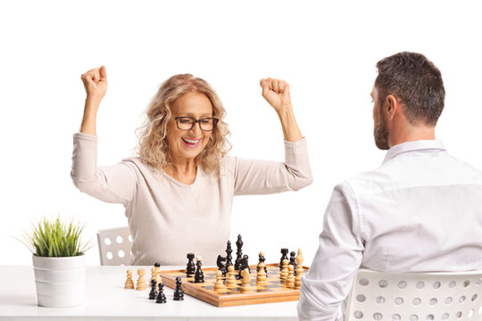Happy woman celebrating a chess victory against a man