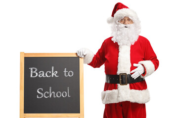Santa claus and a blackboard with text back to school © Ljupco Smokovski
