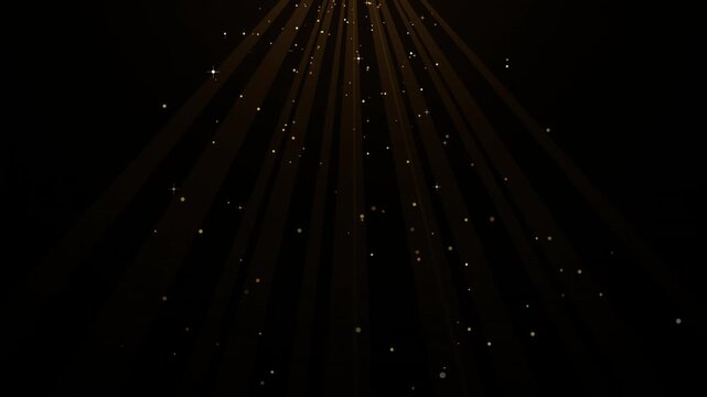 Golden radial particle rays shining downward on black background