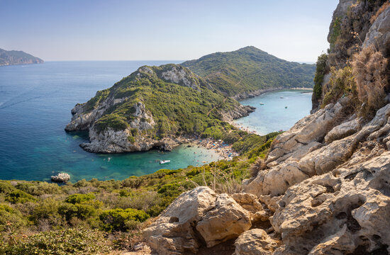 Porto Timoni Beach on the island of Corfu, Greece. Unidentifiable people on the beach.